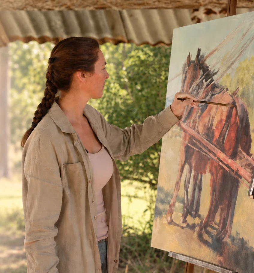 Jo in action painting a horse
